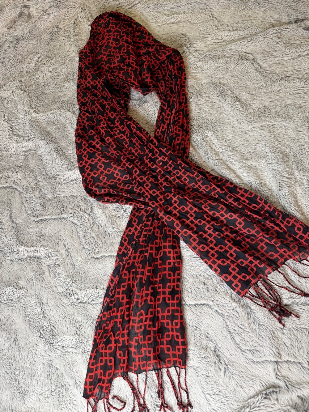 Red and black oblong rectangular geometric scarf with fringe ends